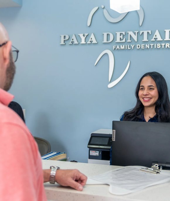 Patient checking in at the Paya Dental front desk