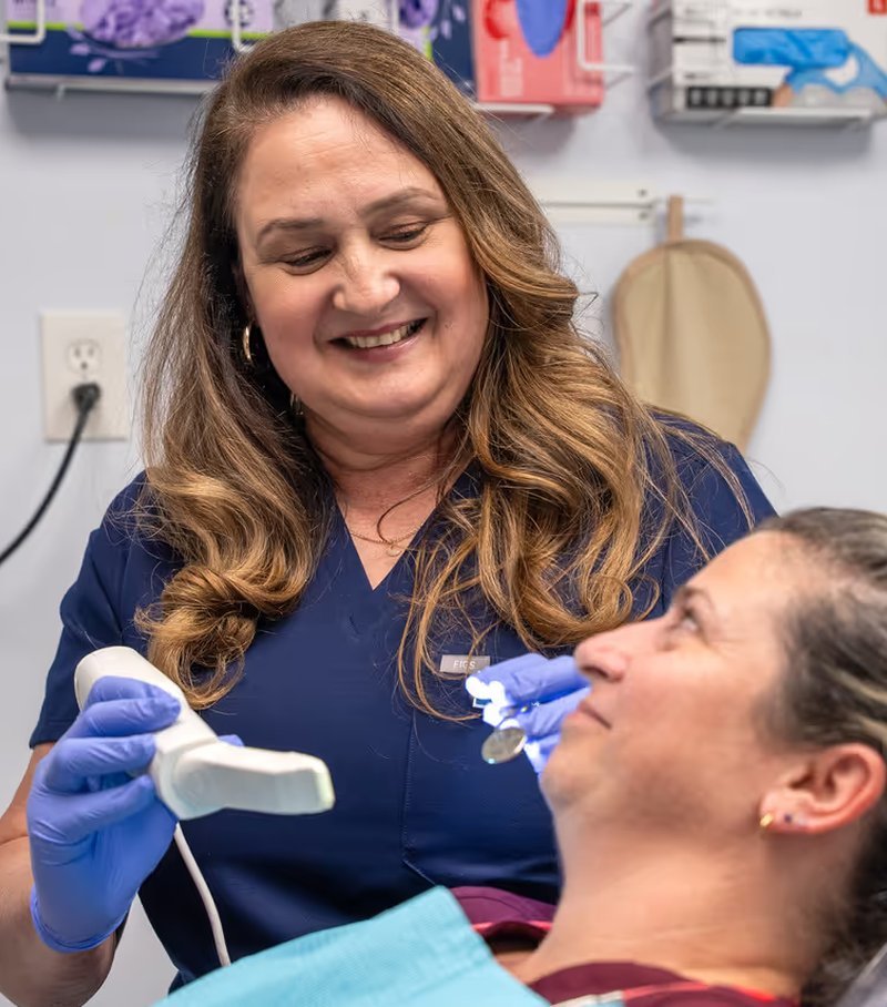 Hygienist caring for a smiling patient