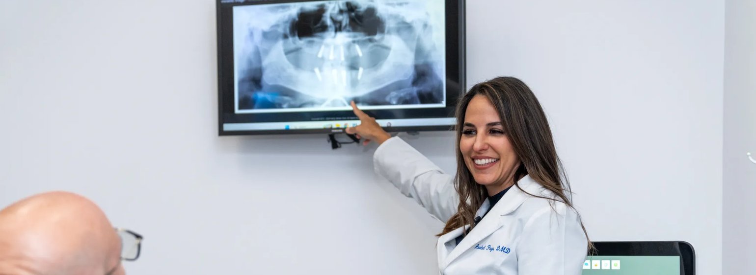 Dr. Anabel Paya reviewing an X-ray with a patient