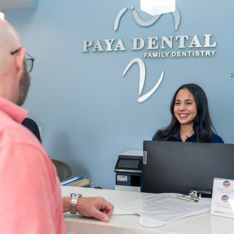 Paya Dental receptionist welcoming a patient