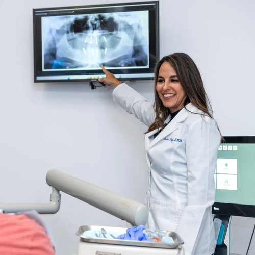 Dentist reviewing an X-ray with a patient