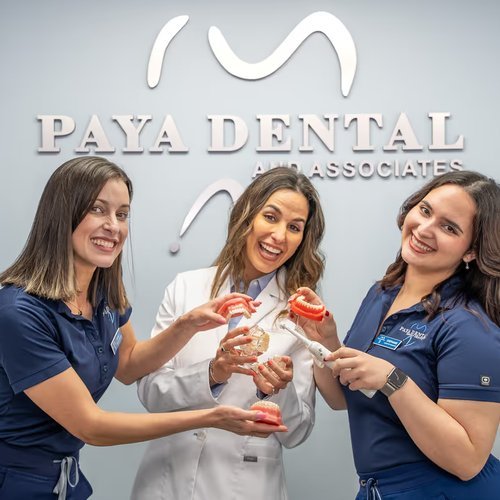 Paya Dental team holding dental models