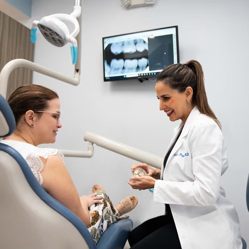 Dentist talking with a patient in the dental chair