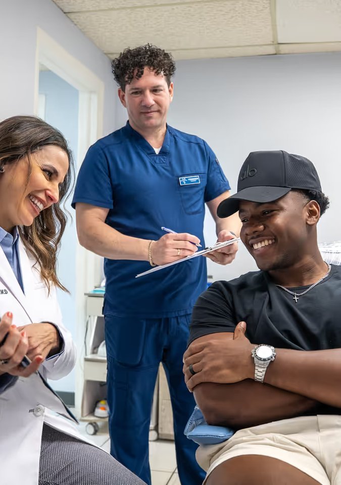 Paya Dental team member with a smiling patient