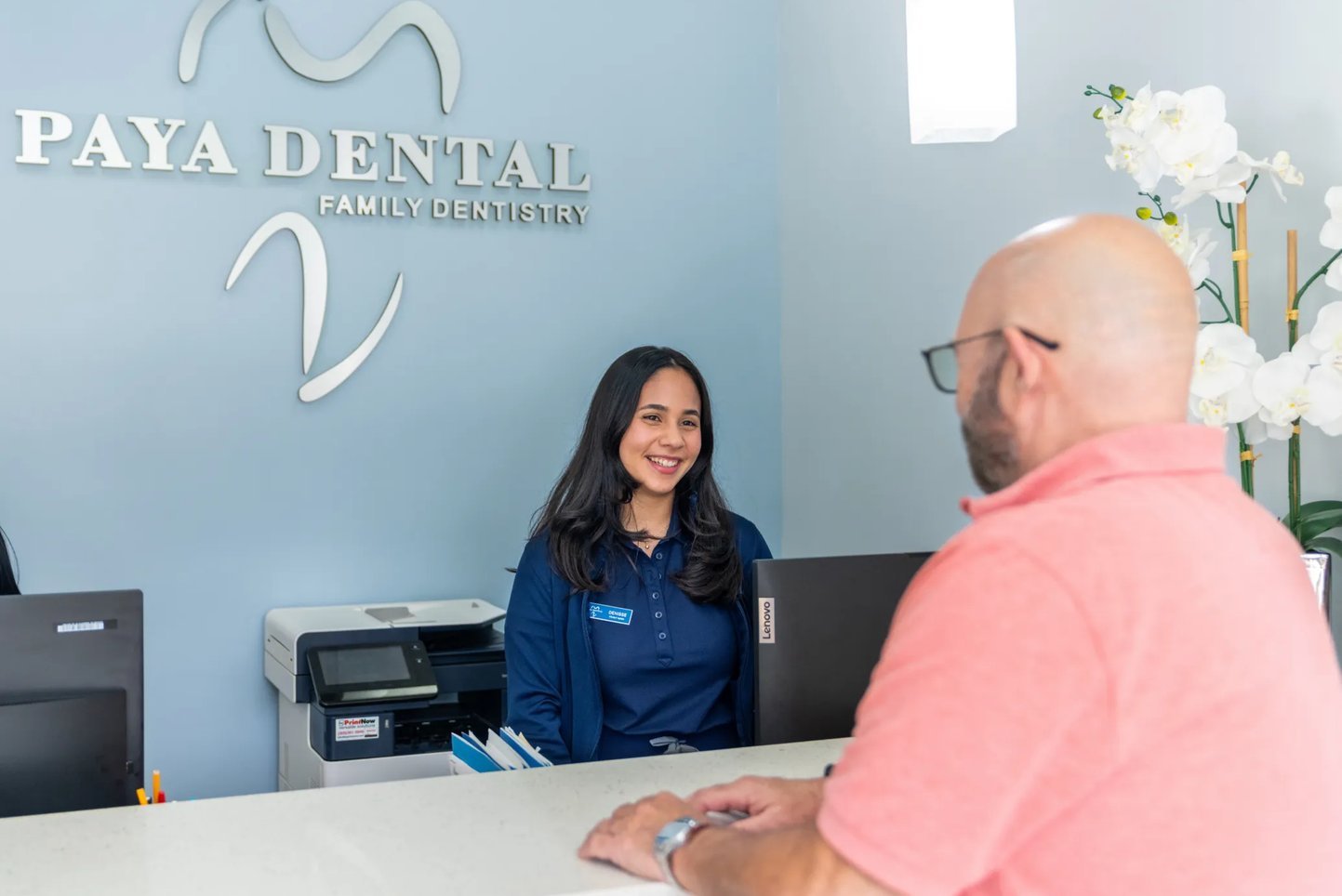 Patient talking with the Paya Dental front desk