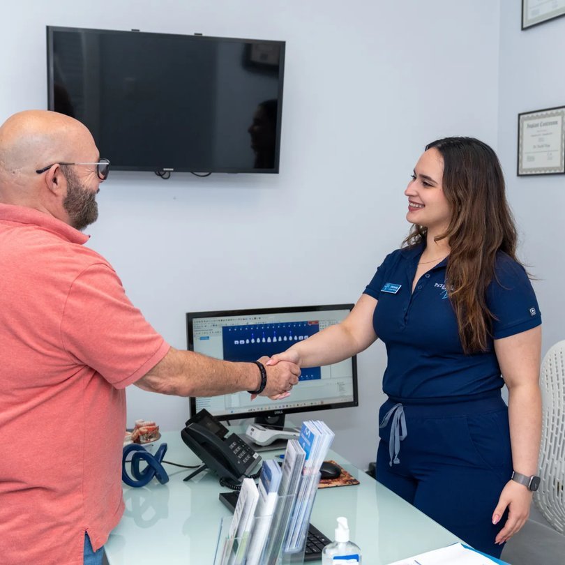 Paya Dental team member greeting a patient
